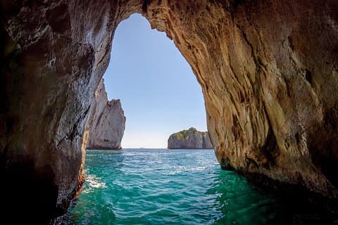 Boat through the iconic Faraglioni rock formations