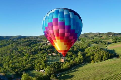 Soar above Tuscany’s rolling hills in the golden morning light.