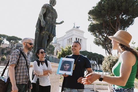 Holding Cleopatra's pic. A statue of Julius Caesar in the back, and the ruins of the Temple of Venus. This is the perfect spot