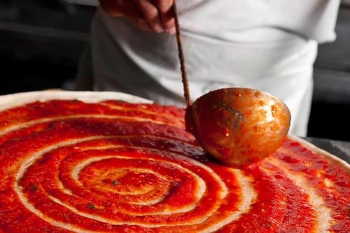Adding tomato sauce
