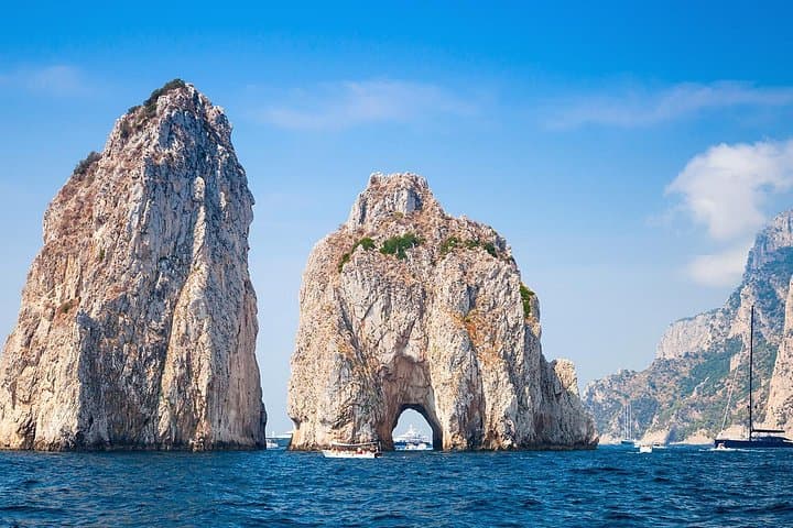 Cruise right through the Faraglioni rocks!