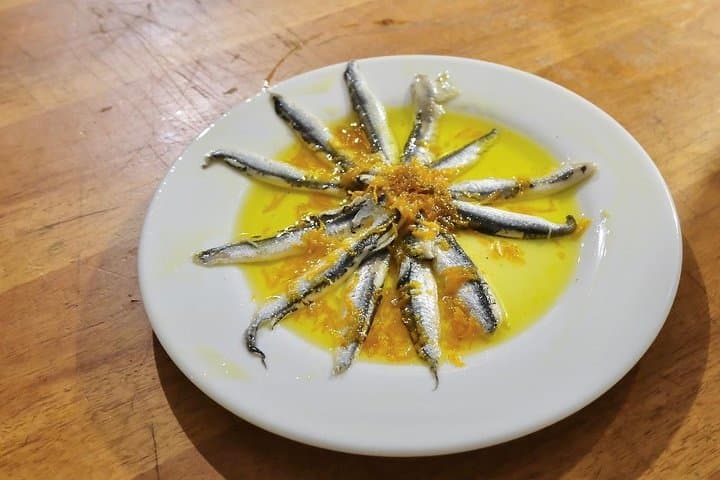 Anchovies marinated in an orange sauce