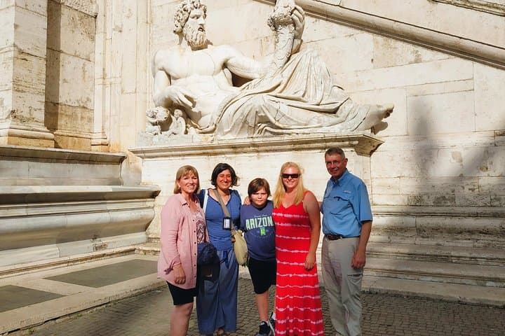 What is the name of the River God just behind this great family?