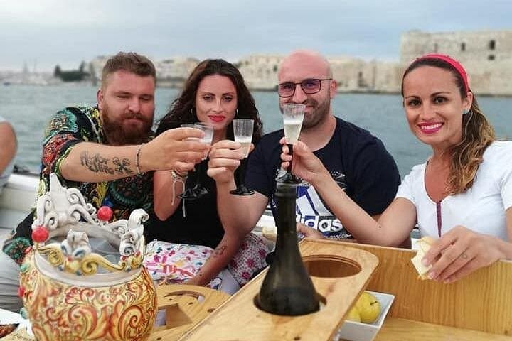 Syracuse Aperitif boat at Sunset island and sea caves