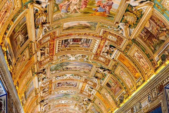 Interior of the Vatican Museums in Rome, showcasing Renaissance frescoes, statues, and priceless works of art