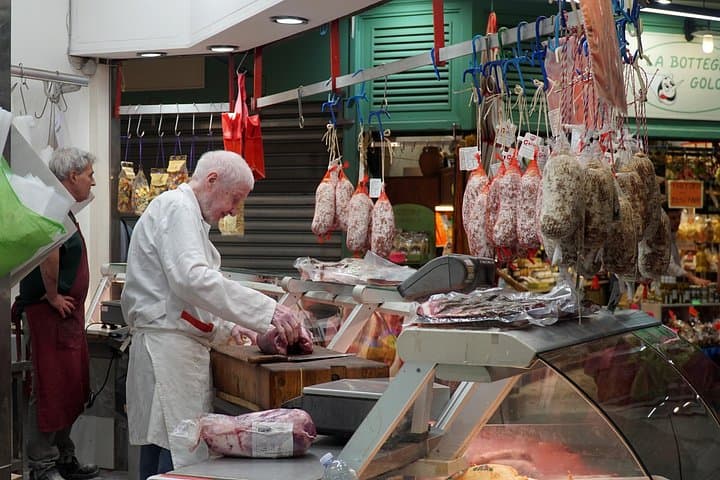 A butcher working hard for his guests looking for the best cuts of meat