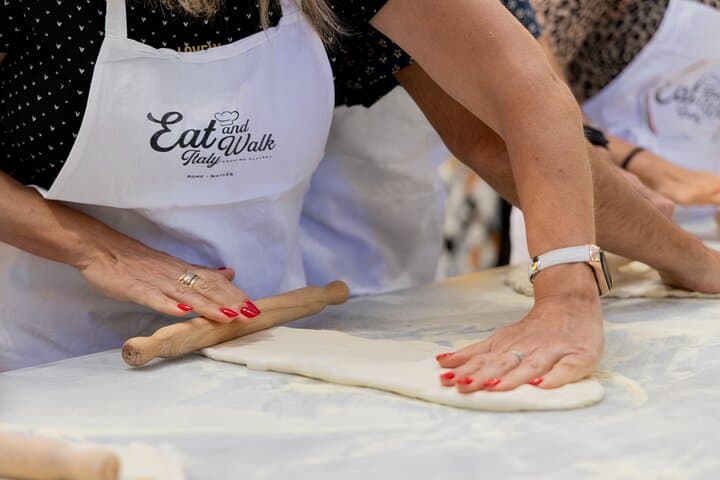 Rolling fresh pasta dough by hand.