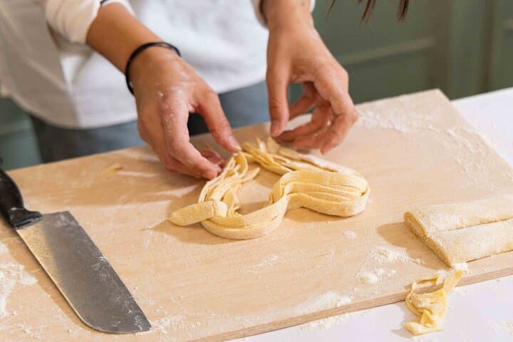 Rolling and cutting fresh pasta dough.