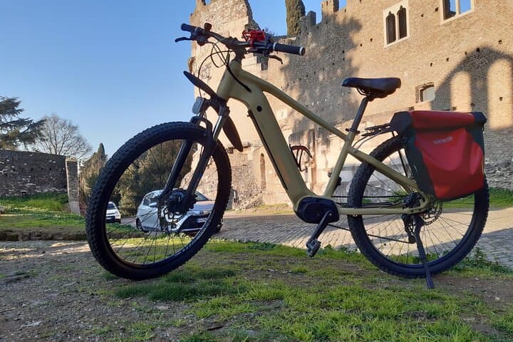 An e-bike in front of the Mausoleum of Cecilia Metella