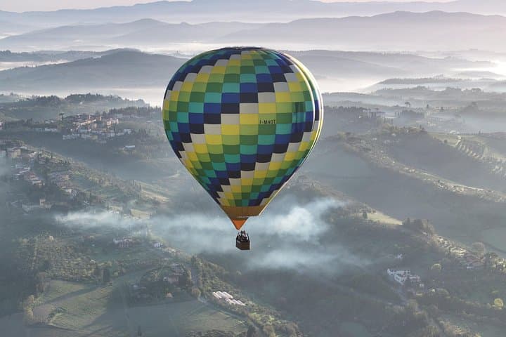 Hot air balloon over the hills of Pienza, Montalcino and Val D'Orcia