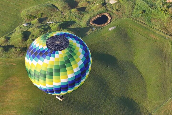 Hot air balloon over the hills of Pienza, Montalcino and Val D'Orcia