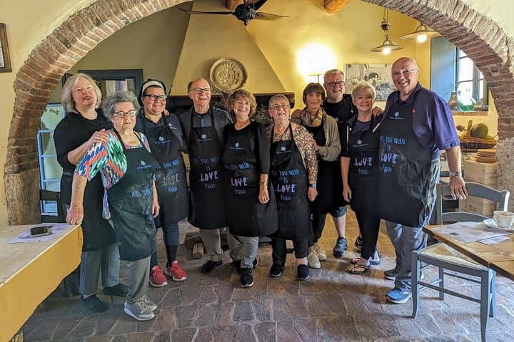 A family making pasta together at the tuscan cooking class of Podere Spedalone!