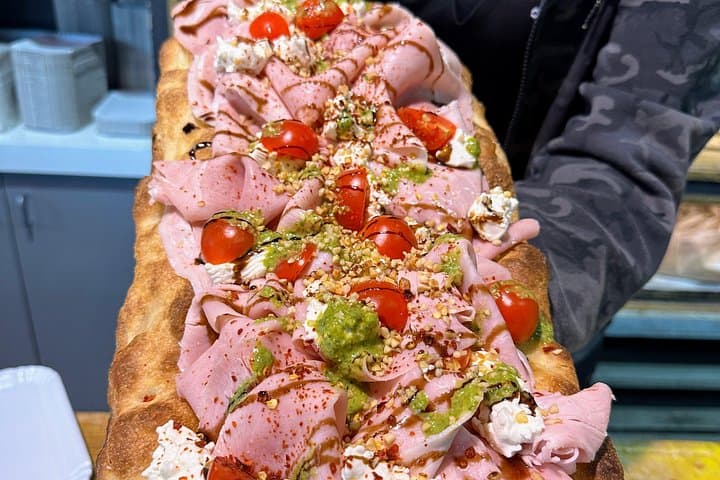 "Pizza alla Pala" with mortadella, cherry tomatoes, burrata, pesto, and pistachios in Trastevere Food Tour.
