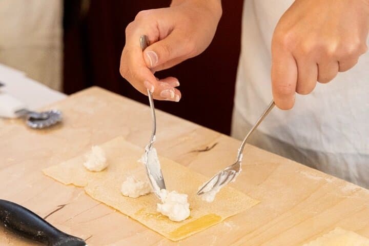 Stuffing ravioli with fresh ricotta cheese.