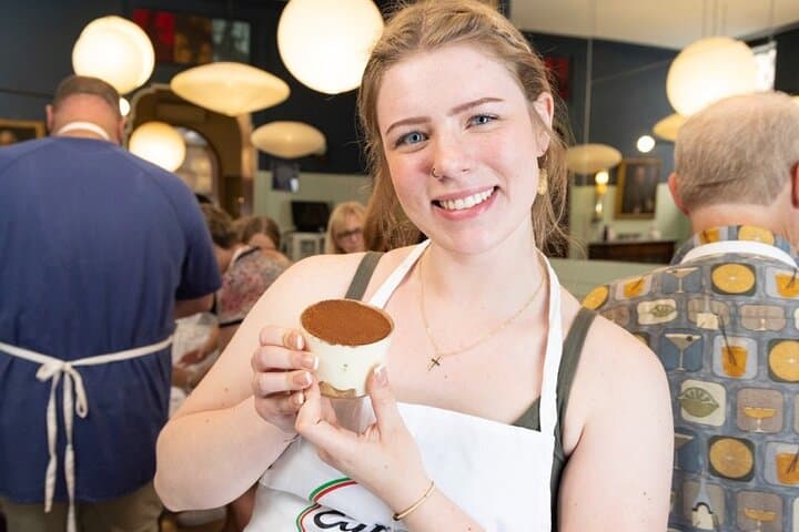 Showing off homemade Tiramisu always with a smile.