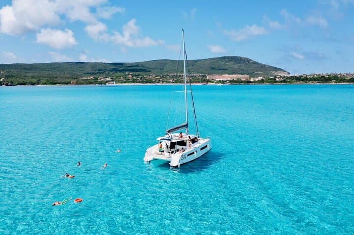 From Stintino: 3-hour catamaran tour with aperitif off La Pelosa