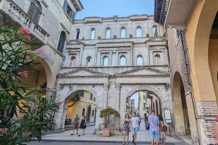 Walk under the ruins of Porta Borsari