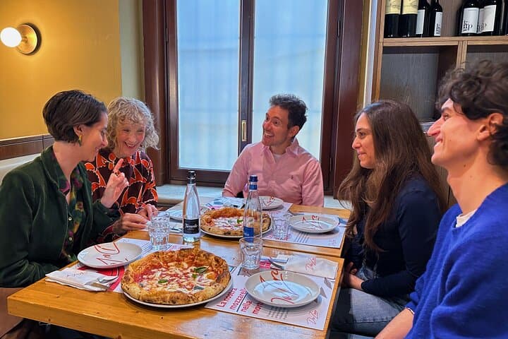 group relaxing over pizza