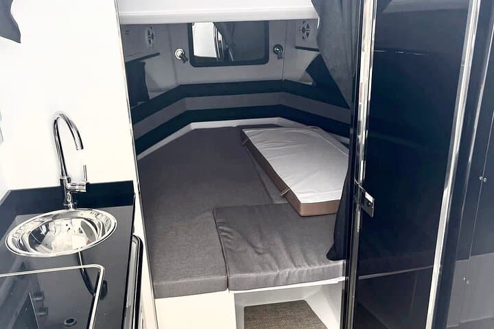 Interior space with loungers on board in our Xamira outboard