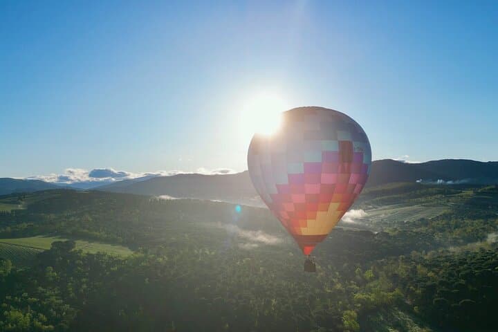 Enjoy stunning views of Chianti vineyards as the sun rises behind your balloon