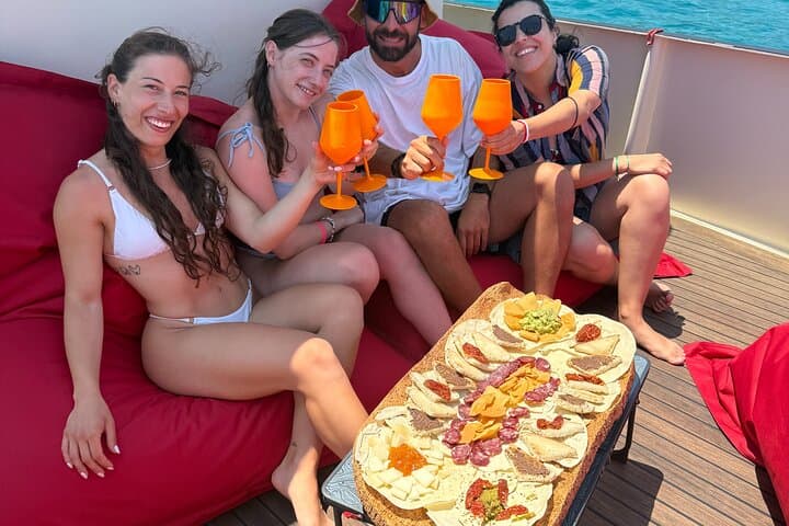 Golfo Aranci sunset on luxury yacht with dolphins and aperitif