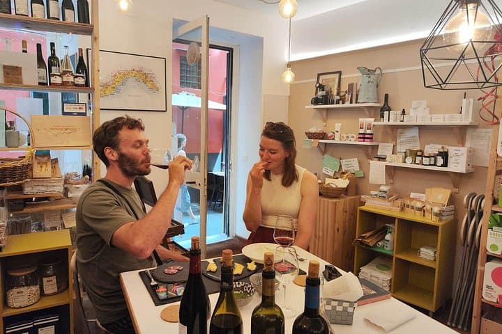 Couple enjoying the guided tasting inside our historic bottega in Genoa