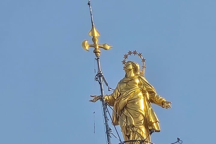 High above Milan, La Madonnina graces the pinnacle of the Duomo—a golden guardian watching over the city, symbolizing faith and protection