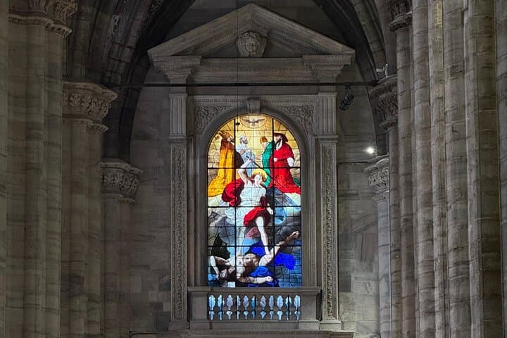Radiant stained glass illuminating the solemn beauty of a Gothic cathedral interior