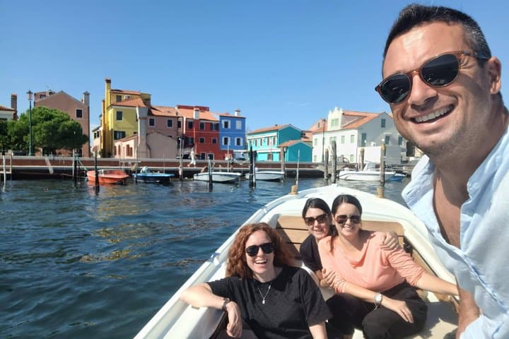 Selfie of the captain with a group of three friends during the boat tour to the island of Pellestrina