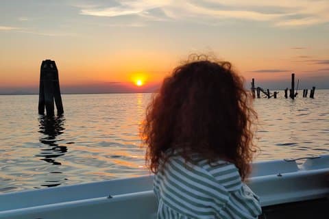 Beautiful view of sunset during boat tour in chioggia venetian lagoon