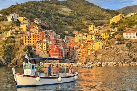 Cinque Terre sunset boat tour with a traditional ligurian gozzo