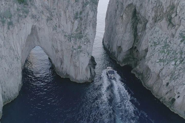 Pass through the Faraglioni rocks