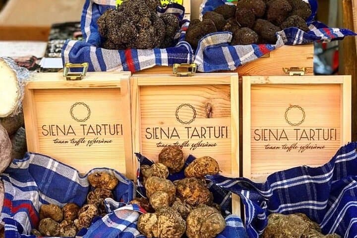 fresh white and black truffles during market in Piazza del Campo square in December.
