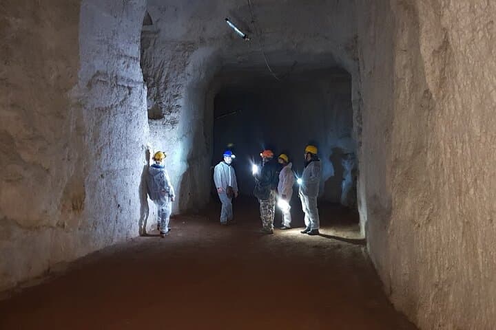 Small groups with torches and helmets