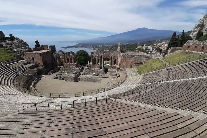 Greek theater of Taormina with the Etna volcano nearby
