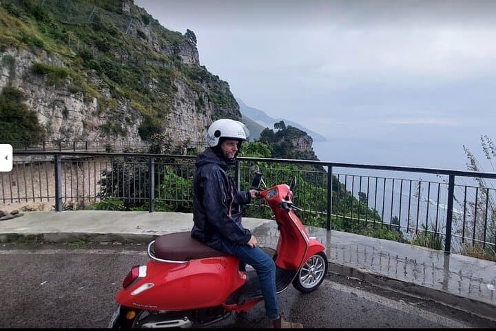 Customer with orange vespa.