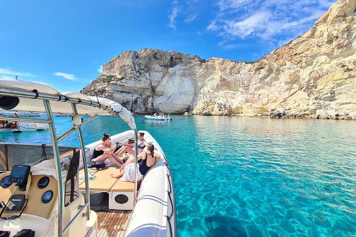 Our dinghy moored under the majestic cliffs of Cagliari. Turquoise waters and relaxation guaranteed.