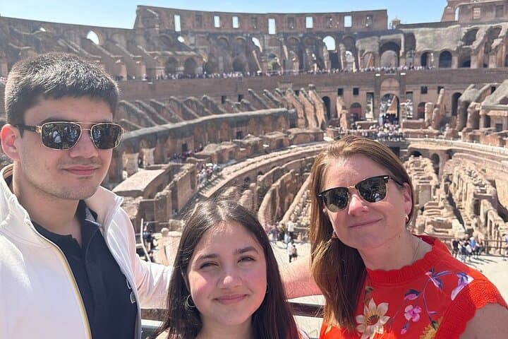 A family enjoying the view of colosseum.