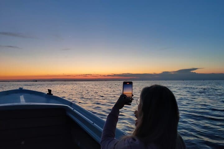 Costumer taking video during sunset boat tour