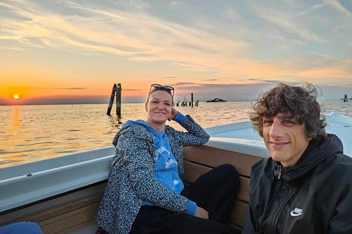 Costumers during boat tour with beautiful sunset in the background