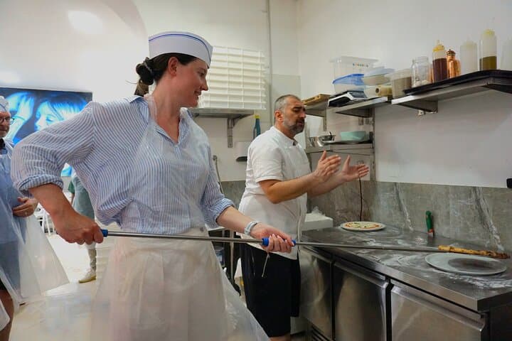 Putting the pizza in the plate, fresh out of the oven!