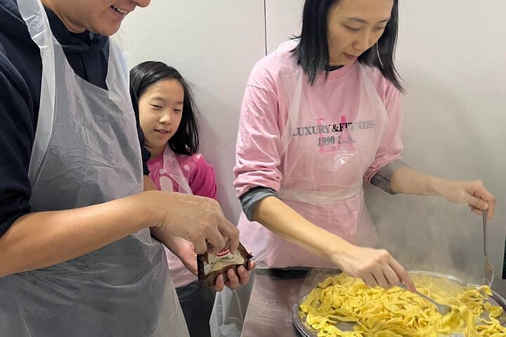 Mixing fettuccine with sauce.