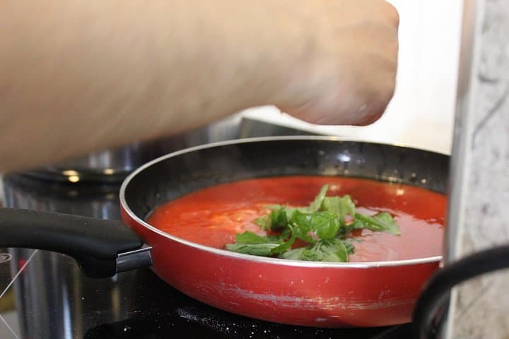 Preparing the tomato sauce.