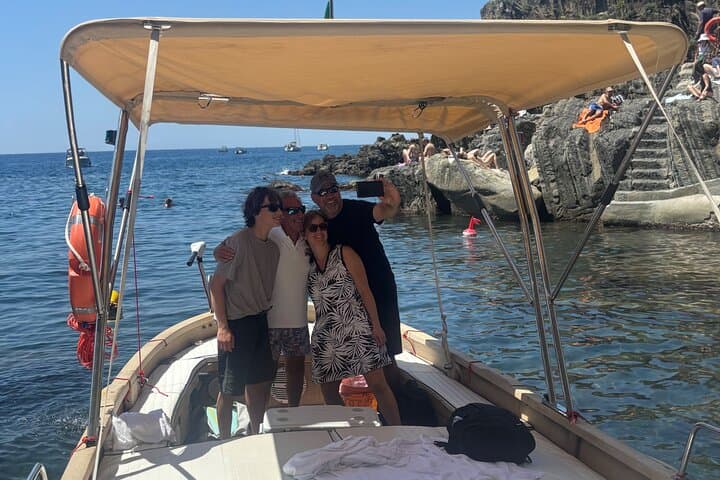 Boat ride from Riomaggiore with stop for swimming and local wine.