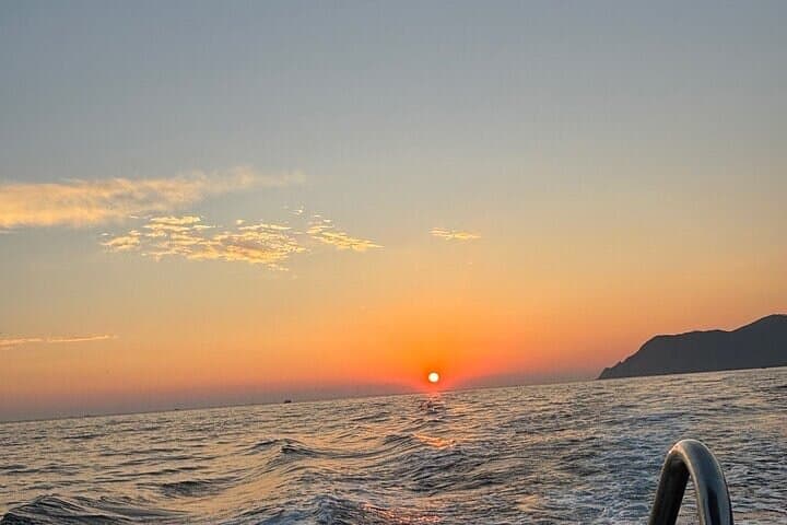 Boat ride from Riomaggiore with stop for swimming and local wine.