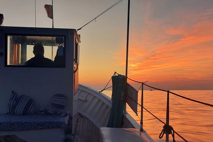 Cinque Terre sunset boat tour with a traditional ligurian gozzo