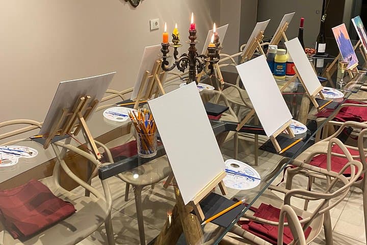Our atelier table set with canvases, brushes, paints, and wine, ready for a fun painting session