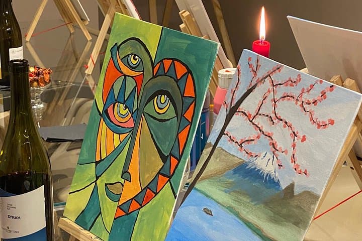 Finished paintings alongside Italian wine, a perfect souvenir of your unique Venetian art experience