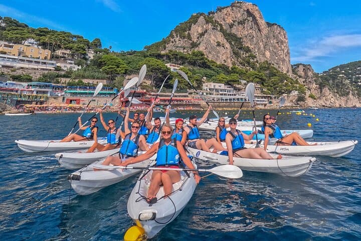 Explore the coast of Capri by kayak, among sea caves and turquoise sea.