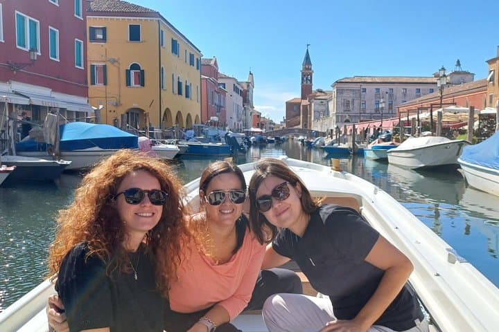 Three beautiful friends photographed by the skipper in the historic center of Chioggia during the boat tour to discover the charm of Chioggia
